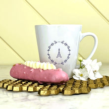 Load image into Gallery viewer, This white latte mug comes with two lavender coloured graphics printed on it, with "bonjour" one one side and the Effiel Tower surrounded by a wreath of flowers on the other: L'Abeille Française