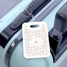 Load image into Gallery viewer, Hard, white plastic luggage tag with gold bee surrounded by pink flowers printed on it