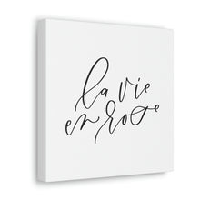 Load image into Gallery viewer, A 10" x 10" square white canvas with the phrase 'la vie en rose' printed on it in a contemporary caligraphic script: L'Abeille Française