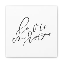 Load image into Gallery viewer, A 10" x 10" square white canvas with the phrase 'la vie en rose' printed on it in a contemporary caligraphic script: L'Abeille Française