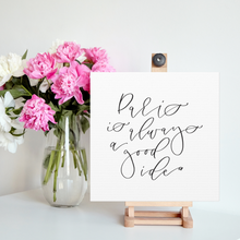 Load image into Gallery viewer, A 10" x 10" square white canvas with the phrase 'Paris is always a good idea' printed on it in a contemporary caligraphic script: L'Abeille Française
