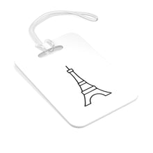 Load image into Gallery viewer, Hard, white plastic luggage tag with a graphic of the Eiffel Tower printed on it in black
