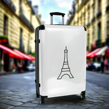 Load image into Gallery viewer, Large hard-shell suitcase with black Eiffel Tower graphic on white background is accented by black trim, back, wheels and telescoping handle: Boutique L'Abeille Française