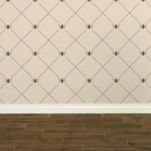 Load image into Gallery viewer, Dark grey bees intersecting diagnonal lines on a cream-coloured wallpaper: L'Abeille Française