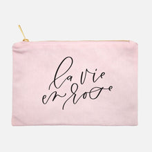 Load image into Gallery viewer, Powder-pink cotton canvas cosmetic bag with 'la vie en rose' printed on the front in black script: L'Abeille Française