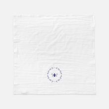 Load image into Gallery viewer, A natural coloured flour-bag cotton tea towel printed with a lavender Bee surrounded by a wreath of flowers graphic: L'Abeille Française