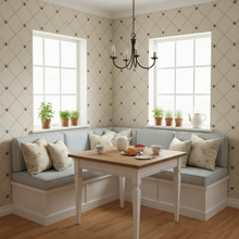 Load image into Gallery viewer, Nook with a wooden table and cushioned bench against a wall with cream-coloured wallpaper with a design of dark grey bees intersecting diagnonal lines: L'Abeille Française