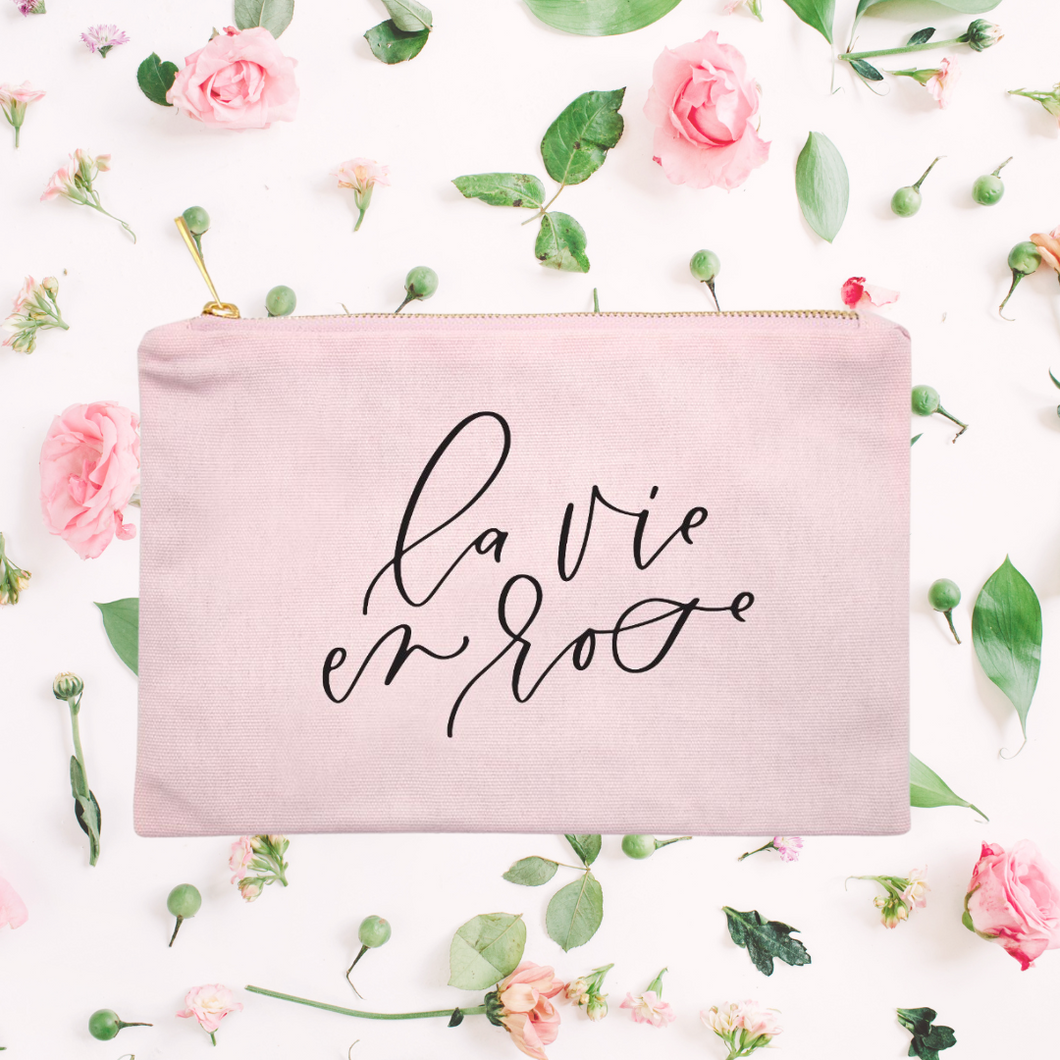 Powder-pink cotton canvas cosmetic bag with 'la vie en rose' printed on the front in black script: L'Abeille Française