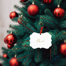Load image into Gallery viewer, Decorated Christmas tree with red ornaments and a &#39;Paix&#39; ornament.