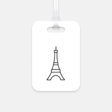 Load image into Gallery viewer, Hard, white plastic luggage tag with a graphic of the Eiffel Tower printed on it in black