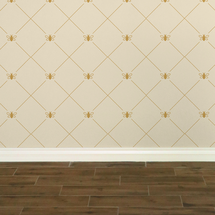 Stylized gold-coloured bees intersecting diagnonal lines on a cream-coloured wallpaper: L'Abeille Française
