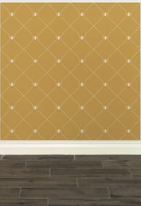 Stylized cream-coloured bees intersecting diagnonal lines on a gold-coloured wallpaper: L'Abeille Française