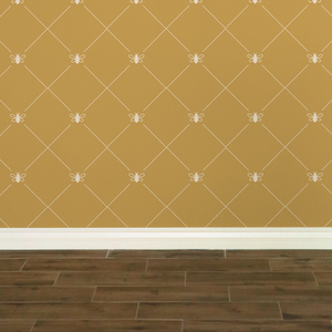 Stylized cream-coloured bees intersecting diagnonal lines on a gold-coloured wallpaper: L'Abeille Française
