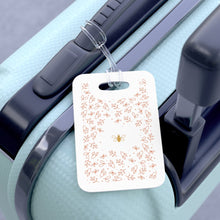 Load image into Gallery viewer, Hard, white plastic luggage tag with gold bee surrounded by pink flowers printed on it 