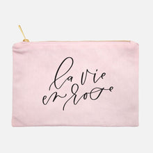 Load image into Gallery viewer, Powder-pink cotton canvas cosmetic bag with &#39;la vie en rose&#39; printed on the front in black script: L&#39;Abeille Française