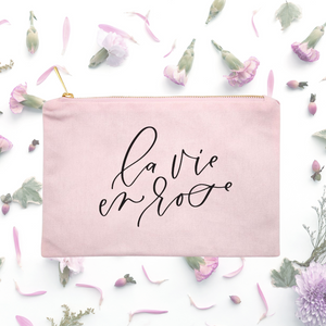 Powder-pink cotton canvas cosmetic bag with 'la vie en rose' printed on the front in black script: L'Abeille Française