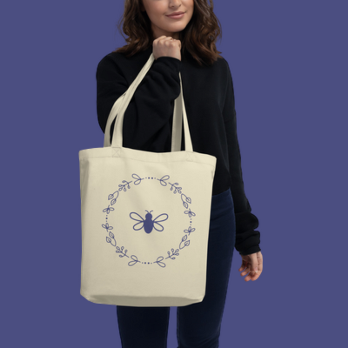 A natural coloured canvas tote bag with a lavender bee and wreath motif