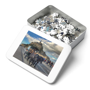 14" × 11" 252 precise interlocking piece jigsaw puzzle of a team of horses pulling a passenger wagon in front of Mont Saint Michel in France in a white metal box: L'Abeille Française