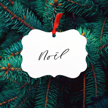 Load image into Gallery viewer, A &#39;Noél&#39; ornament against a Christmas tree background