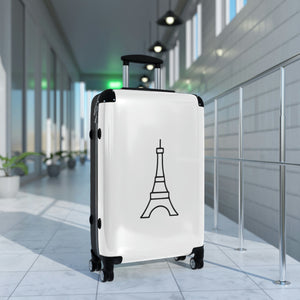 Medium-sized hard-shell suitcase with black Eiffel Tower graphic on white background is accented by black trim, back, wheels and telescoping handle: Boutique L'Abeille Française